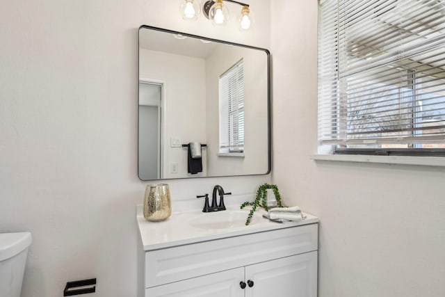 bathroom featuring vanity and toilet