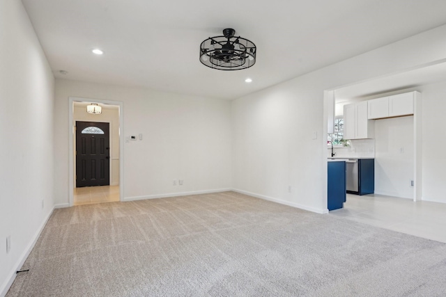 unfurnished living room featuring ceiling fan and light colored carpet