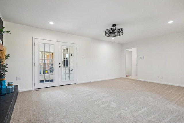 unfurnished room with french doors and carpet flooring