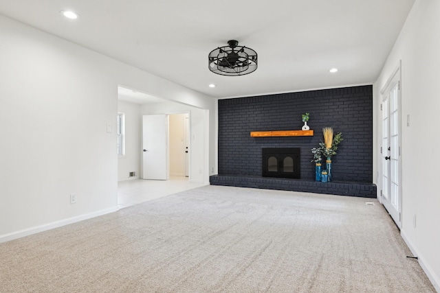 unfurnished living room featuring light carpet and a fireplace