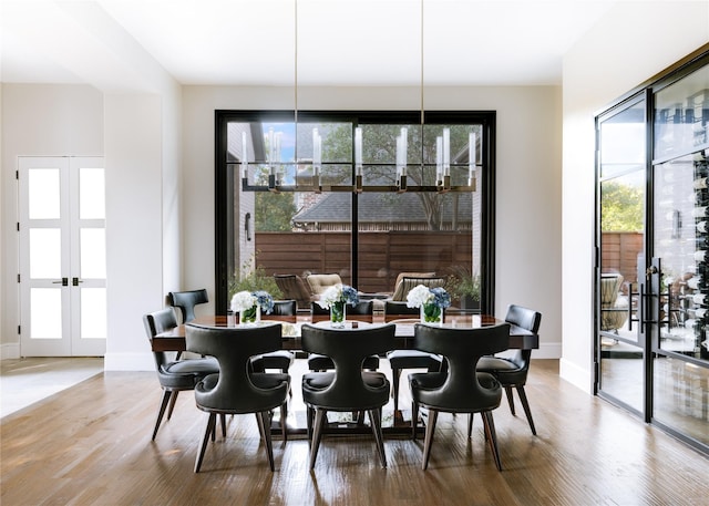 dining area with french doors and wood-type flooring