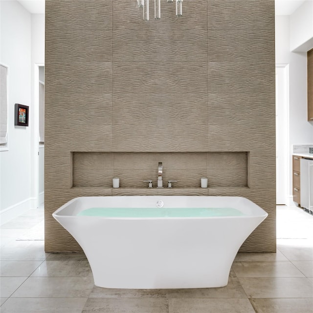 bathroom featuring tile patterned floors, a bathing tub, and tile walls