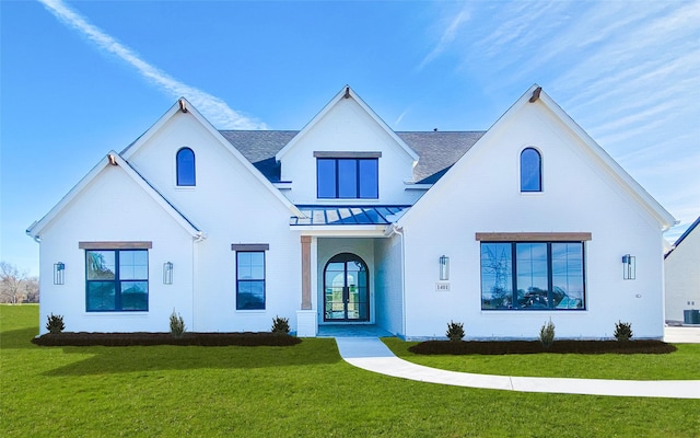 modern farmhouse style home featuring central air condition unit, french doors, and a front lawn