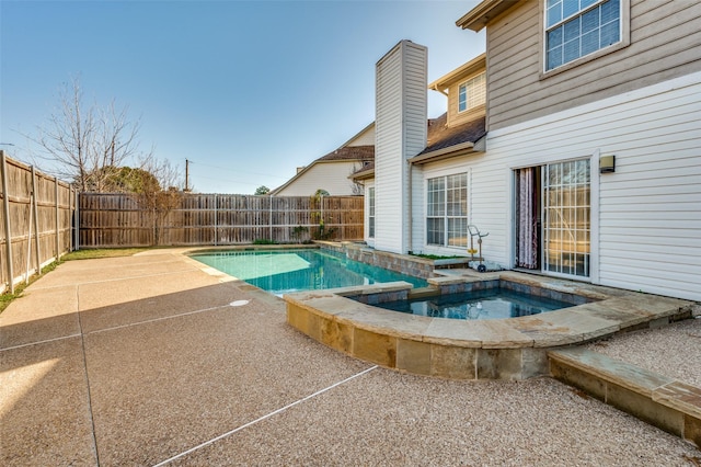 view of pool featuring an in ground hot tub and a patio