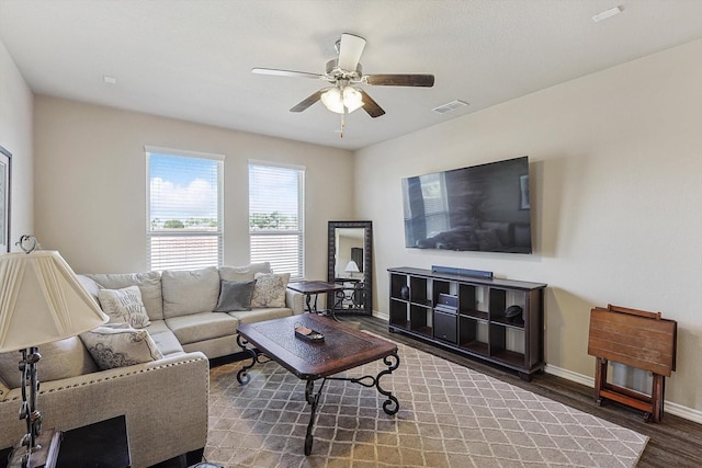 living room featuring dark hardwood / wood-style floors and ceiling fan