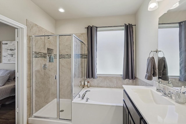 bathroom with vanity and independent shower and bath