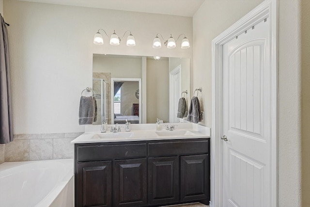 bathroom featuring separate shower and tub and vanity