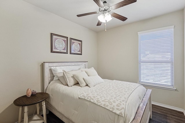 bedroom with ceiling fan and dark hardwood / wood-style floors