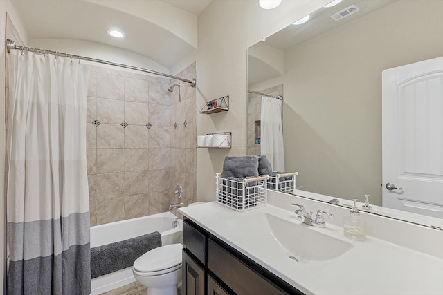 full bathroom with vanity, shower / bath combo, and toilet