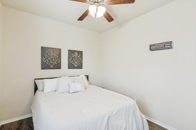 bedroom with ceiling fan and dark hardwood / wood-style flooring