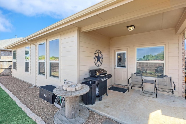 view of exterior entry with a patio