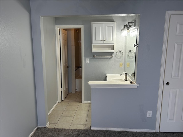 bathroom with tile patterned floors and vanity