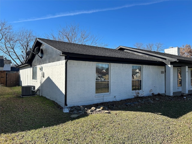 view of home's exterior with a yard and central AC unit