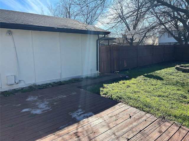 wooden deck featuring a lawn