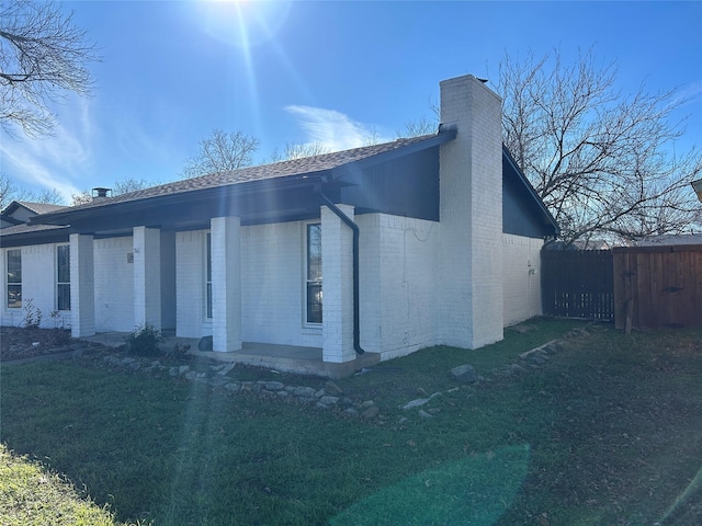 view of property exterior with a lawn