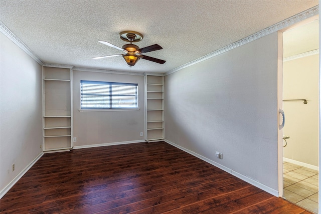 unfurnished room featuring dark hardwood / wood-style flooring, a textured ceiling, ceiling fan, and built in shelves