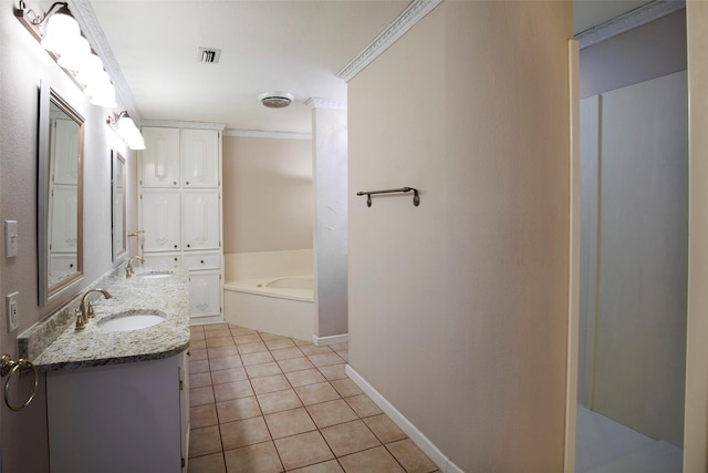 bathroom featuring vanity, tile patterned floors, ornamental molding, and a bathing tub