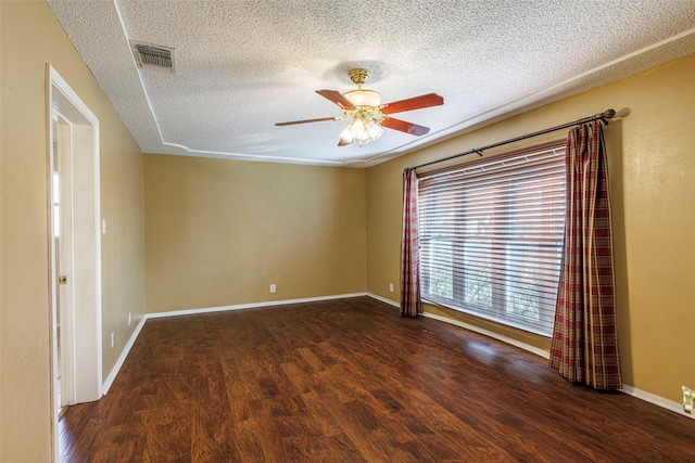 unfurnished room featuring a textured ceiling, ceiling fan, and dark wood-type flooring