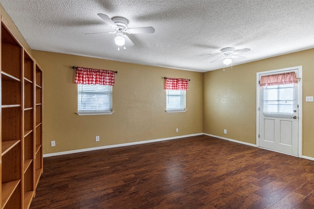 unfurnished room with ceiling fan, dark hardwood / wood-style floors, and plenty of natural light