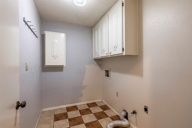 washroom featuring electric dryer hookup, a textured ceiling, washer hookup, and cabinets