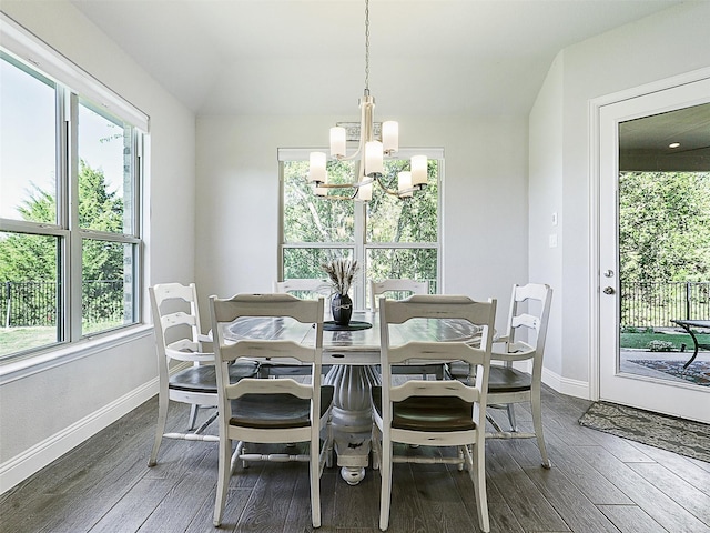 dining room featuring a notable chandelier and dark wood-type flooring