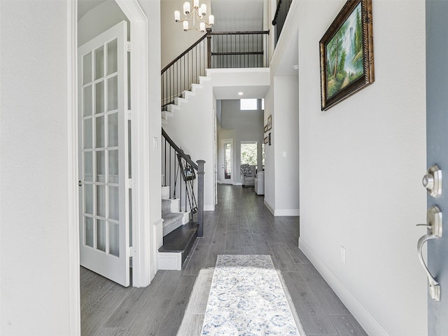 foyer featuring a towering ceiling and a notable chandelier