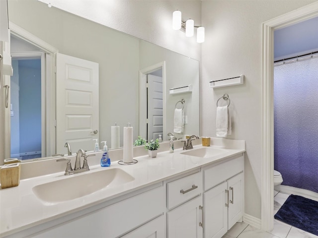 bathroom featuring tile patterned floors, vanity, a shower with shower curtain, and toilet