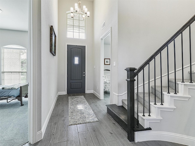 foyer entrance with a chandelier and a towering ceiling