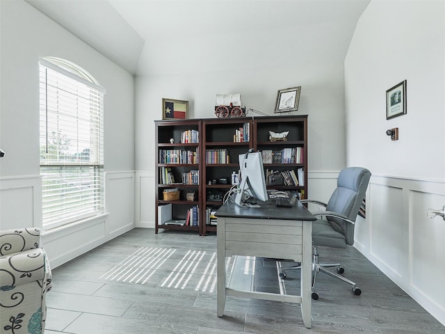 office with dark wood-type flooring and lofted ceiling