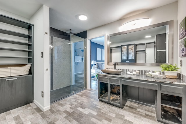 bathroom featuring vanity and a shower with shower door