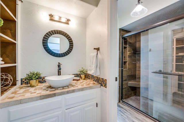 bathroom with vanity, hardwood / wood-style flooring, and an enclosed shower