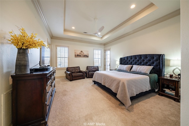 carpeted bedroom featuring a raised ceiling, ceiling fan, and crown molding