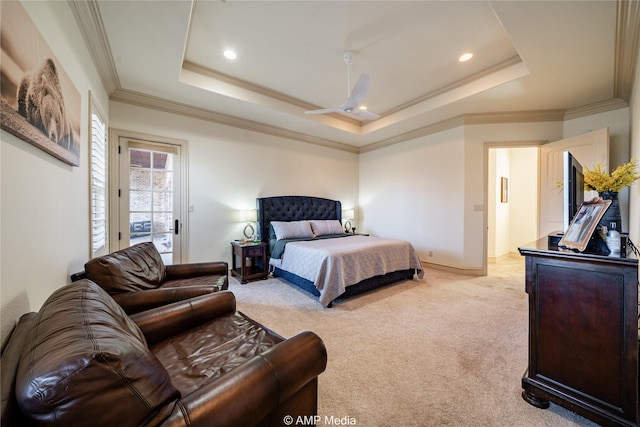 carpeted bedroom with a raised ceiling, ceiling fan, and crown molding