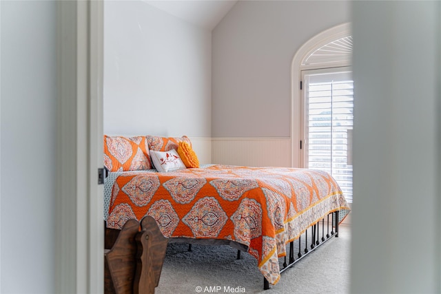 carpeted bedroom with lofted ceiling