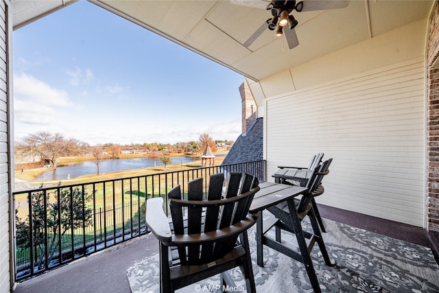 balcony featuring ceiling fan and a water view