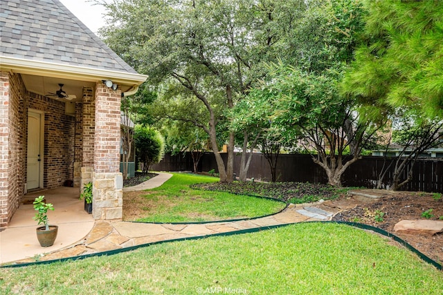 view of yard with ceiling fan