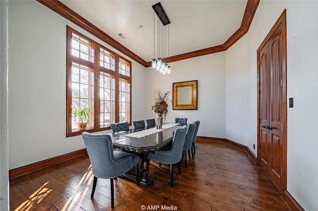 dining area featuring dark hardwood / wood-style floors and crown molding