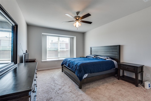 bedroom with light carpet and ceiling fan