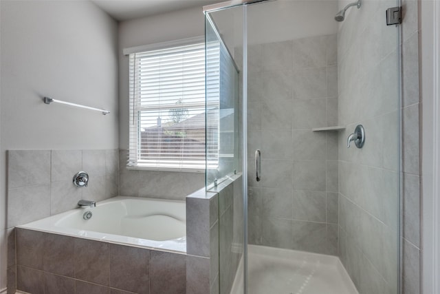 bathroom featuring shower with separate bathtub