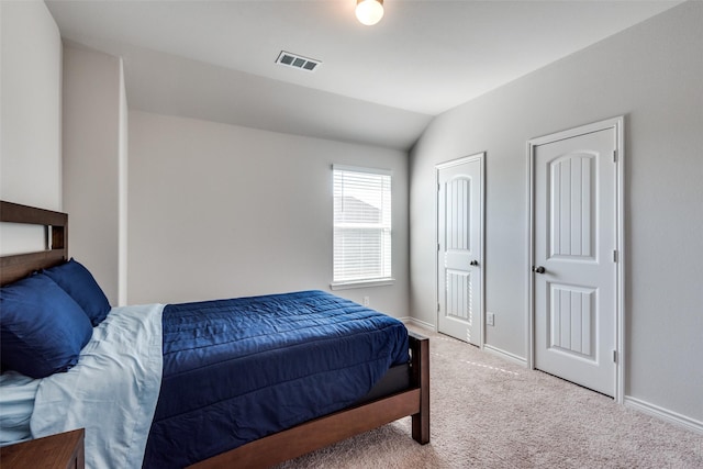 bedroom featuring carpet and vaulted ceiling