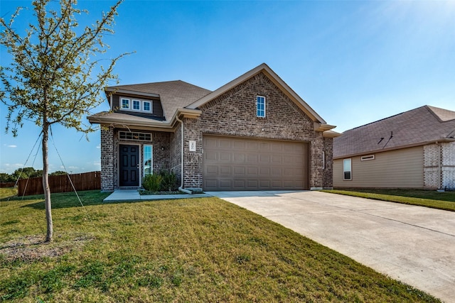 view of front of property with a garage and a front lawn