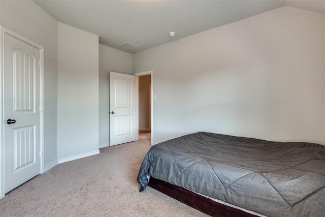 carpeted bedroom featuring vaulted ceiling