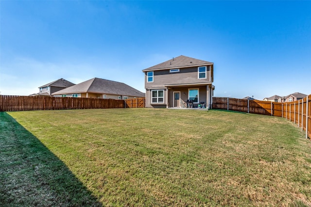 back of property featuring a lawn and a patio