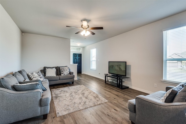 living room featuring hardwood / wood-style floors, ceiling fan, and a healthy amount of sunlight