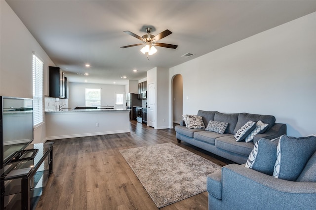 living room featuring hardwood / wood-style flooring and ceiling fan