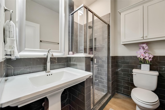 bathroom with walk in shower, sink, hardwood / wood-style floors, and toilet