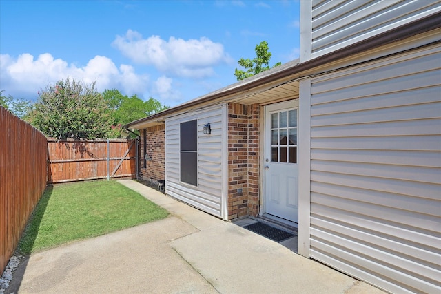 view of exterior entry featuring a patio