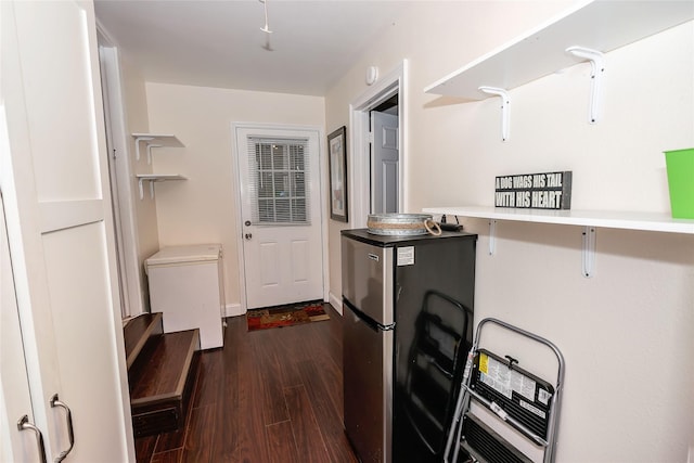 kitchen with refrigerator, dark wood-type flooring, and stainless steel refrigerator