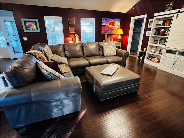 living room featuring vaulted ceiling and dark wood-type flooring