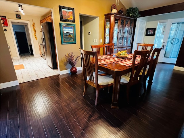 dining space featuring lofted ceiling and hardwood / wood-style flooring